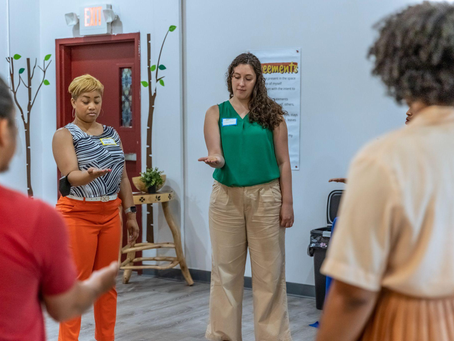 A group of people in a circle having a healing-centered group discussion