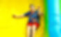 Close up of a boy sliding down an inflatable slide.