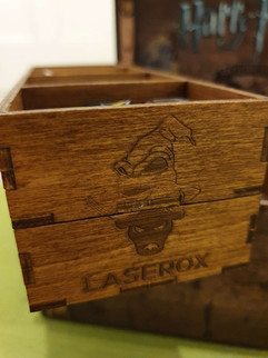 A closeup of the end section of one of the dividers in the Howarts Battle Organizer showing the Laserox logo and a Sorting Hat