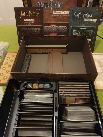 The Harry Potter Hogwarts Battle game box with base game and expansion components inside