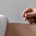 close-up-hand-holding-acupuncture-needle.jpg
