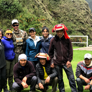 Hikers, porters and chef smiling for a group photo