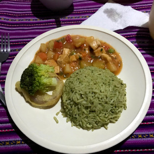 Rice, chicken stew and broccoli on a plater