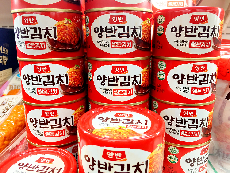 Bright red cans of kimchi for sale at a grocery store in Seoul