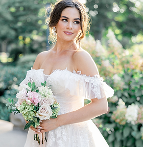 bride holding a bouquet of pink flowers