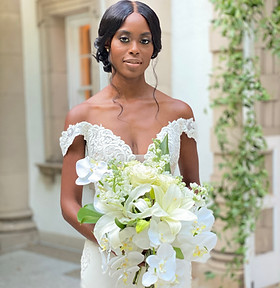 bride holding a bouquet of white flowers