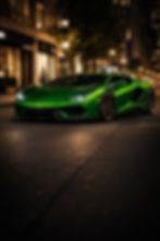 Red Ferrari SF90 Stradale parked on wet urban street at night – hybrid supercar rental PrestigeJetSet