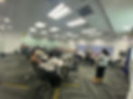 Group of participants seated in a conference room, engaging in a training session with active discus