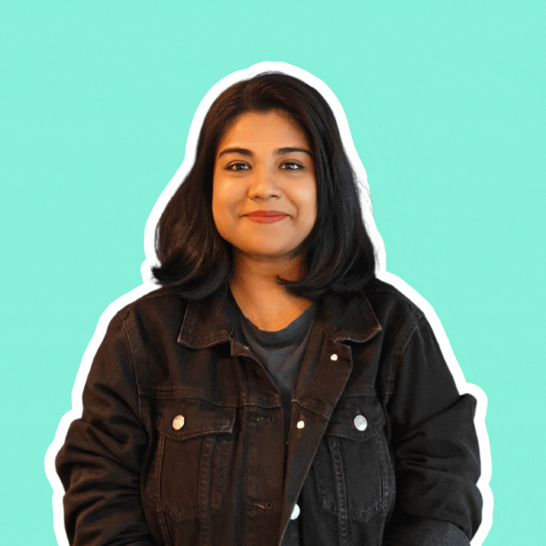 A gif of Emellia Shariff featuring her smiling and doing a fun pose after.