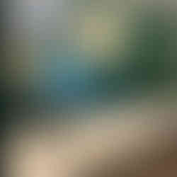 dark green bathroom with stone counters and wooden vanity