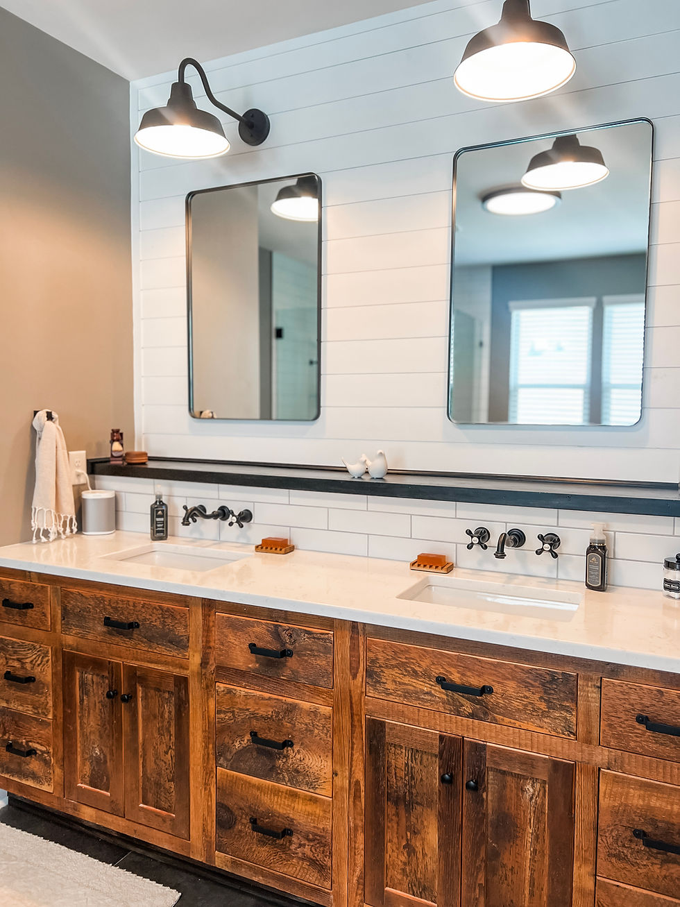 home remodel near Davidson NC features bathroom with subway tile, wooden vanity with double sinks and vintage inspired light fixtures and mirrors
