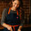 Thumbnail: Smiling woman wearing Midnight Blue Apron Classic, preparing food in kitchen