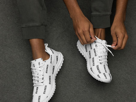 Person putting on shoes to start workout.