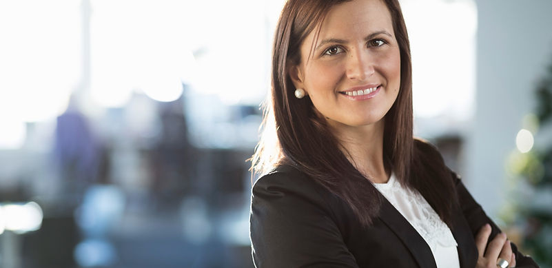 Confident businesswoman smiling, arms crossed