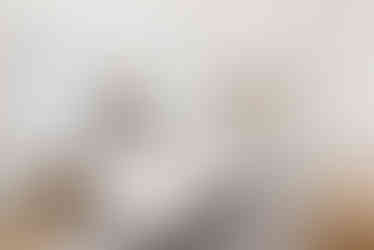 Sun-filled primary suite featuring a custom built-in window seat with storage drawers.