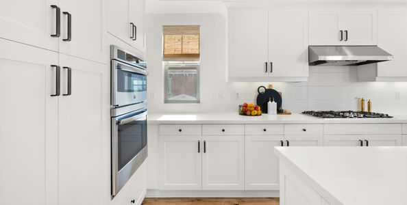 Modern kitchen featuring stainless steel double wall ovens, a gas cooktop