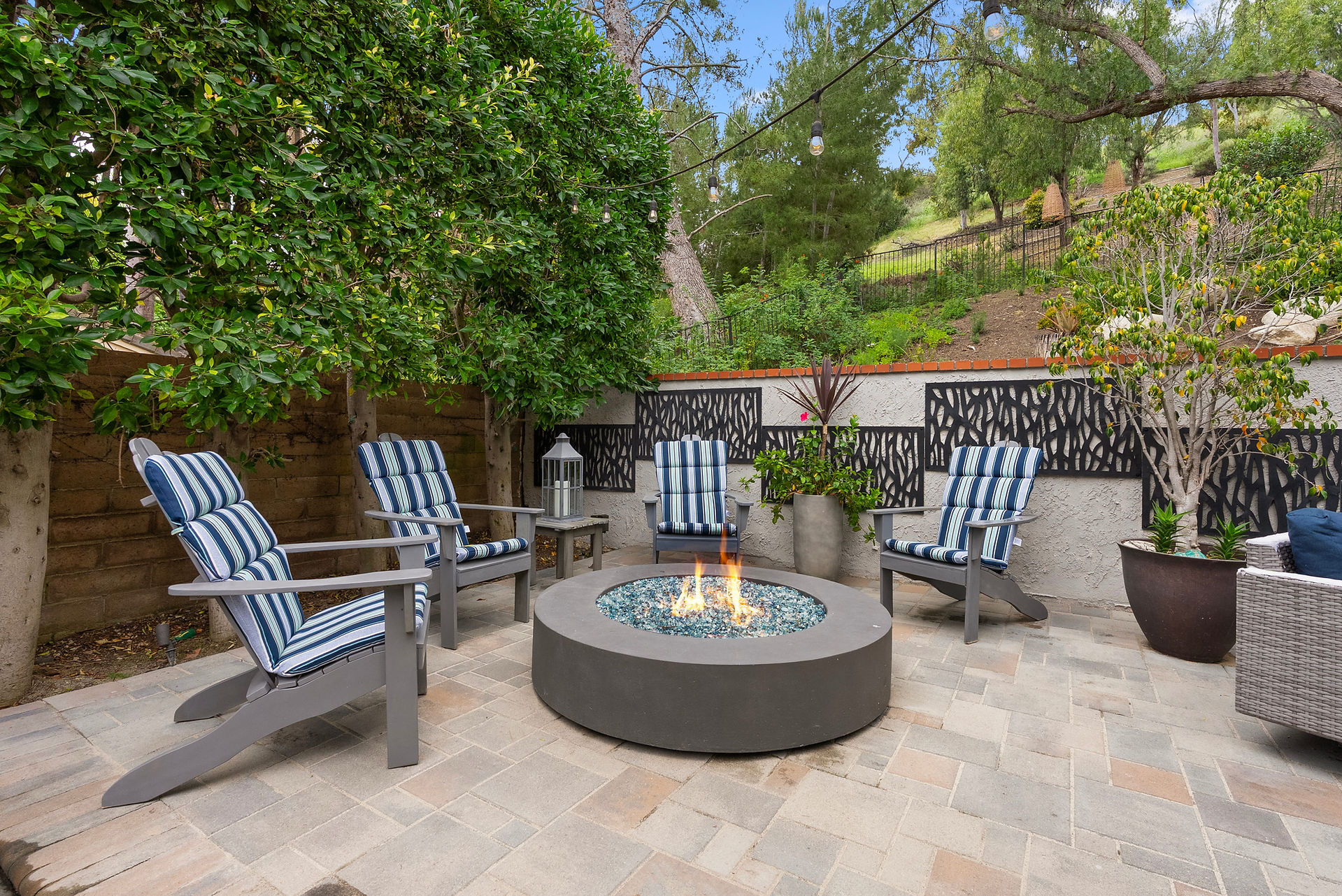 Cozy outdoor patio featuring a fire pit and hillside views.