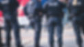 German police squad formation in protective gear with _Police_ logo on uniform maintain pu