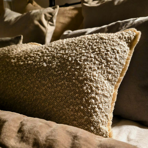 Comfortable boucle cushions for a cosy neutral bedroom design in Manchester.