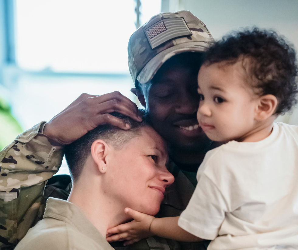A soldier in uniform hugging his family, representing specialized mental health treatment for Kentucky veterans and families.