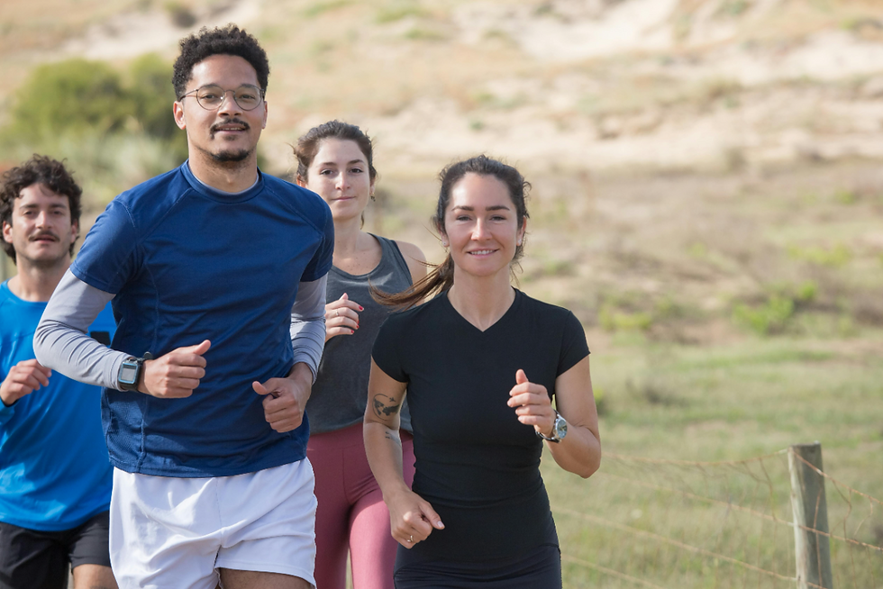 A group of four adults, two men and two women, smiling while jogging outdoors in a natural setting. The Chateau Difference: Long-Term Wellness for Payson Residents is highlighted as they engage in a healthy activity near Payson, UT. This image represents the comprehensive well-being and integrated approach provided by the mental health treatment center in Payson, UT.