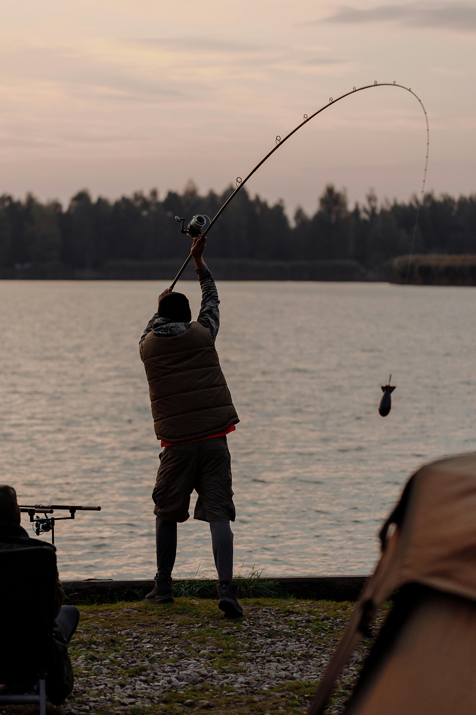 A person fishing at sunset, representing holistic recovery and mind-body wellness approaches.