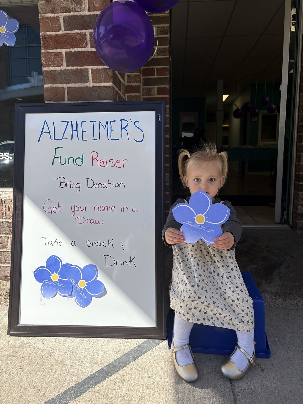 One of our little Earth Angels holding up a flower representing the Alzheimer Society of Nova Scotia.