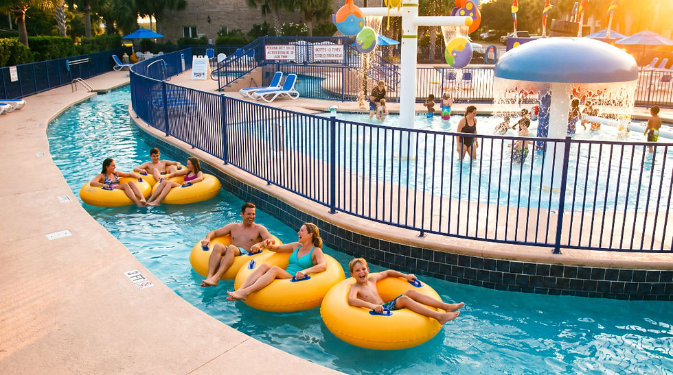 Guests swimming in Grand Palms Resort's lazy river complex. Make Grand Palms Resort your next Myrtle Beach vacation rental.