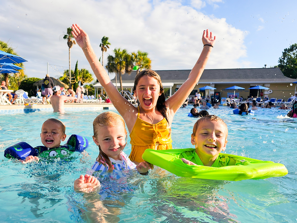 Kids playing in the large Outdoor Pool at Grand Palms Resort. Outdoor Pool, Indoor Pool, Lazy River, Splash Pad, Zero Entry Kiddie Pool, Day Spa, Complimentary Beach Shuttle, and more at Grand Palms Resort.