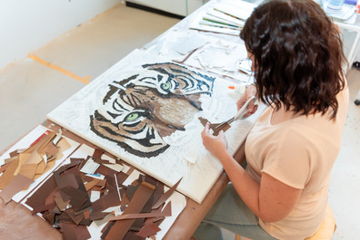 female artist cutting magazine clippings for her art