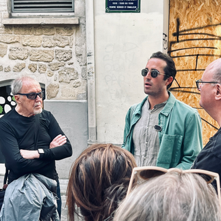 Samuel, wearing sunglasses and a green shirt, stands with Brian, wearing sunglasses and a black shirt