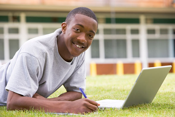college-student-using-laptop-on-campus-lawn-SBI-301022482.jpg