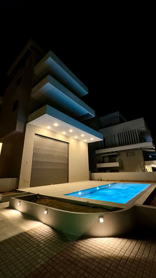 new pool and night view of apartment complex