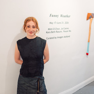 Woman at Funny Weather exhibit with axe art