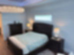 Modern Master Wing bedroom with dark wood furniture.