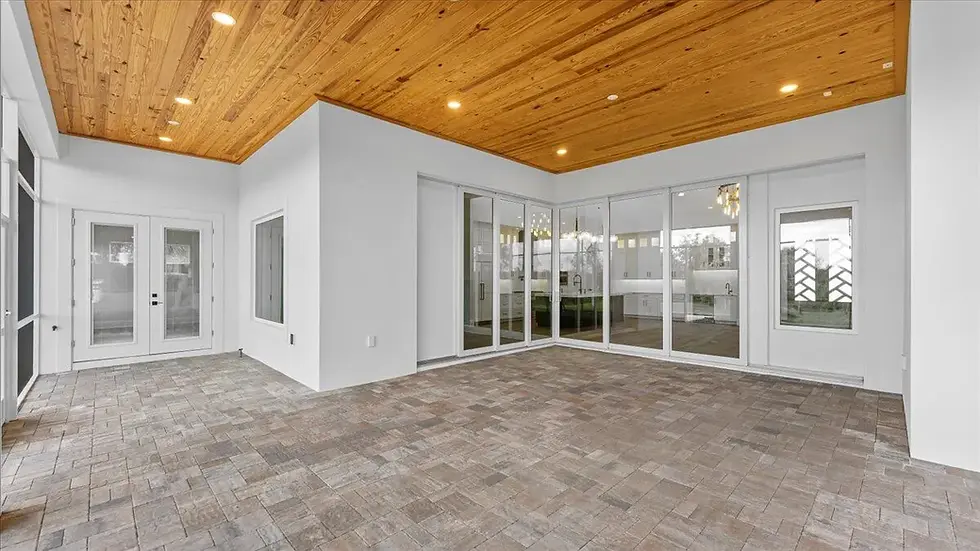 Modern patio with wood ceiling and sliding glass doors