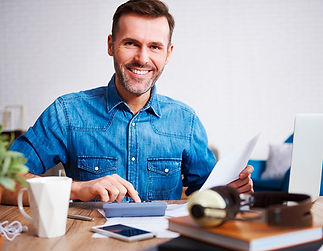 portrait-of-smiling-man-calculating-his-monthly-ex-sm.jpg