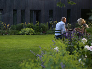 The couple is eating breakfast while the garden is being watered
