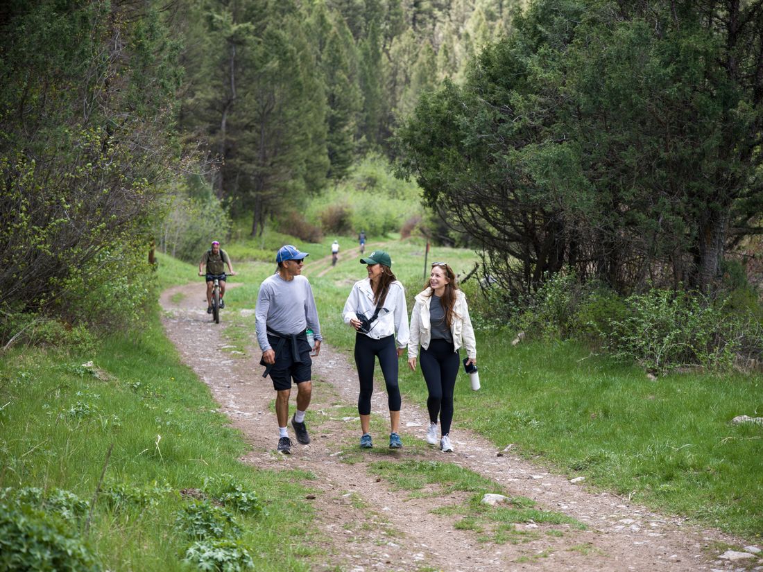 Friends hiking a forest trail in Jackson Hole