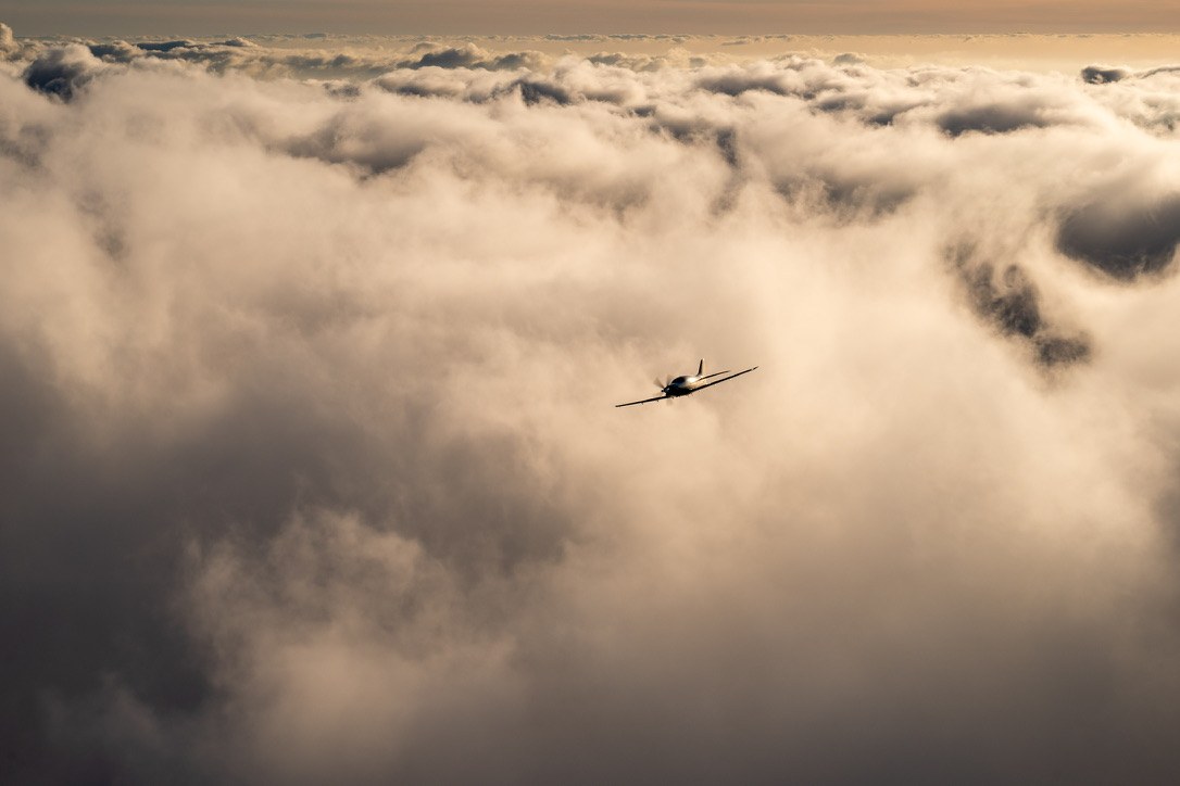 Epic Aircraft project: a small plane flying into a golden cloud deck