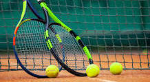 Tennis racquets and balls by net.jpg