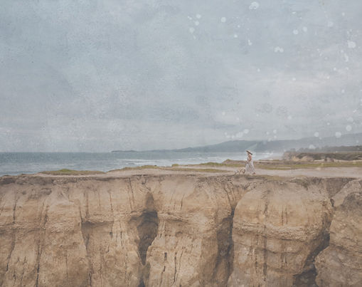 Lar standing on a cliff overlooking the ocean