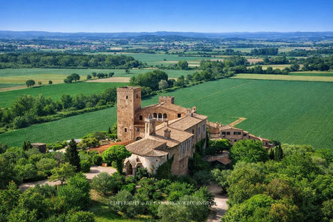 Aerial view of Castell Empordà 14th-century castle wedding hotel surrounded by olive groves, La Bisbal d'Empordà, Costa Brava