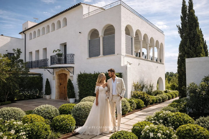 Wedding couple at white villa entrance of Masia Casa del Mar, Les Roquetes del Garraf, near Sitges Spain