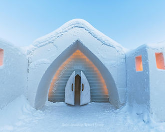 Embark on a cross-border journey from Levi to the enchanting Swedish village of Jukkasjärvi. Discover the iconic Icehotel, a masterpiece crafted from ice and snow. Book your winter excursion now on the Scandinavian Travel Group's website. 
