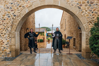 Wedding couple entering a medieval-style stone venue in Lloret de Mar – Costa Brava destination wedding