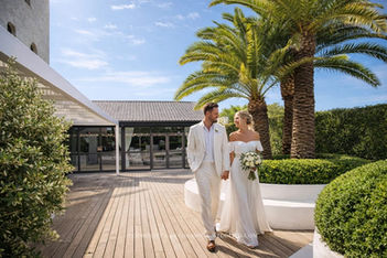 Wedding couple on palm-shaded terrace at Masia Casa del Mar, Les Roquetes del Garraf, near Sitges Spain