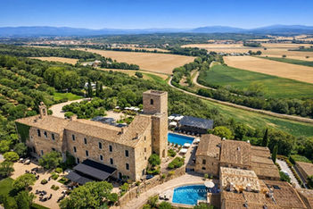 Aerial view of Castell Empordà castle hotel with pool, La Bisbal d'Empordà, Costa Brava Spain
