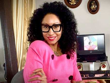 stylish female designer poses in a hot pink vintage dress