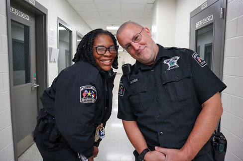 Two detention officers smiling